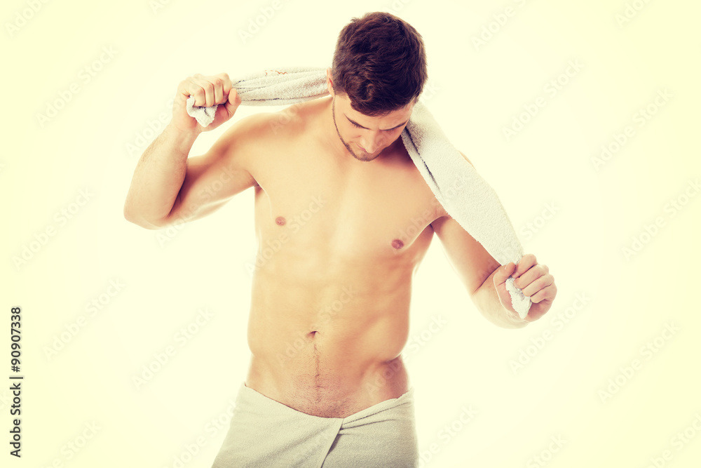 Fototapeta premium Young athletic man with a towel.