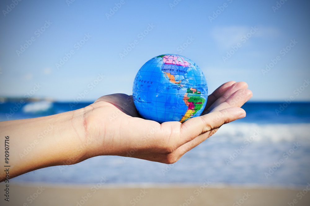 Φωτογραφία young man with a world globe in his hand, vignetted