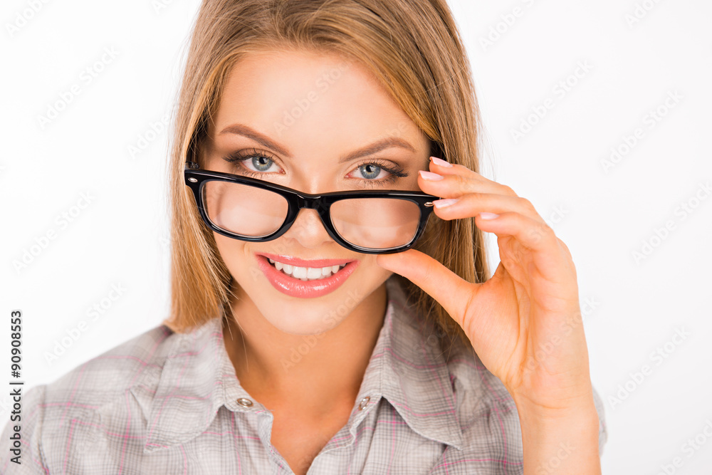 cute young woman adjusting her glasses and smiling cute young woman adjusting her glasses and smiling