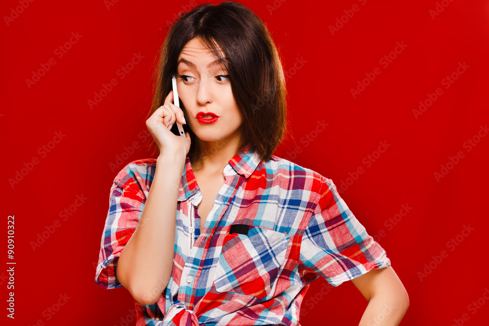 Attractive young brunette woman talking on her mobile phone Attractive young brunette woman talking on her mobile phone