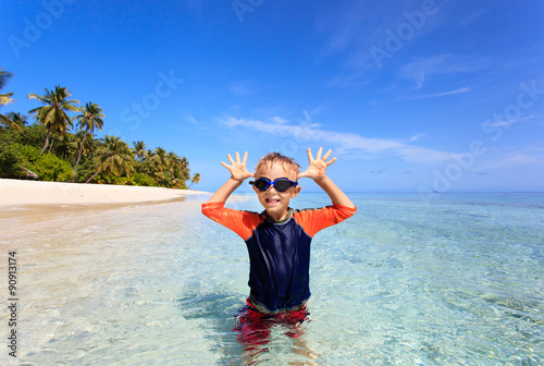 little boy having fun on tropical beach