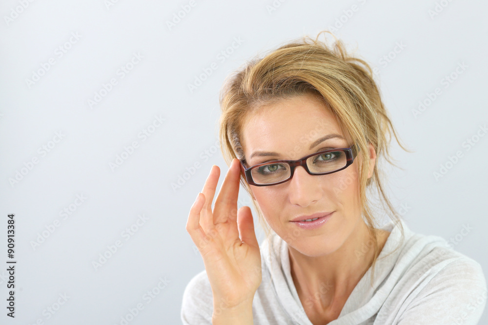 Portrait of blond woman with eyeglasses on, isolated