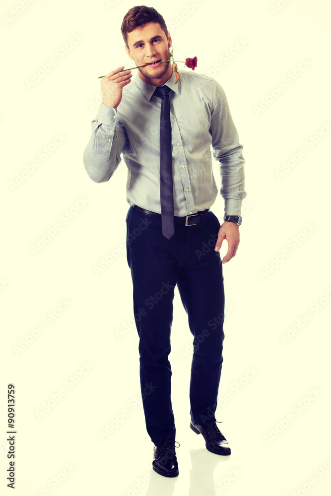Handsome man holding red rose in his mouth. Handsome man holding red rose in his mouth.