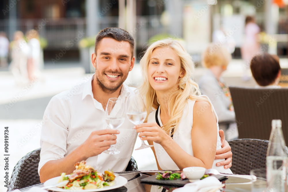 happy couple clinking glasses at restaurant lounge