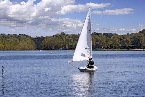 Small white boat Sailing on the lake