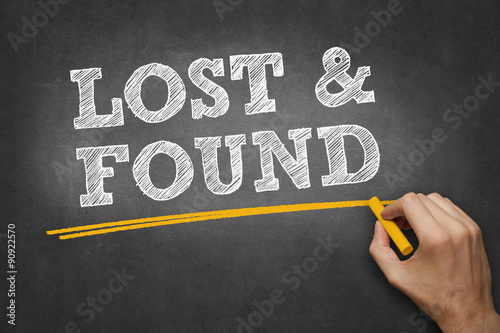 hand writes chalk text on blackboard - lost and found