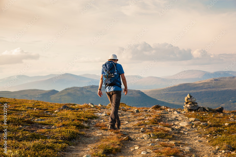 hiker with backpack travelling in Norway mountains Dovre hiker with backpack travelling in Norway mountains Dovre