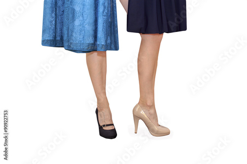 choice of outfit. Woman chooses dress shoes with high heels and dress isolated on white