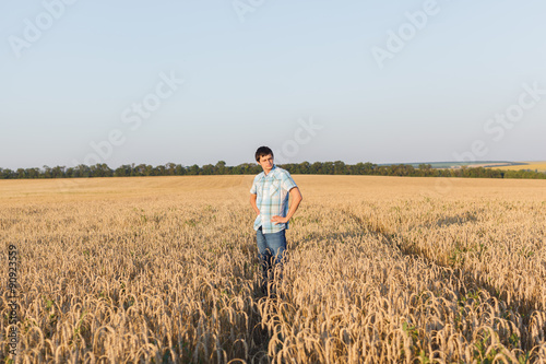 man on wheat field © producer