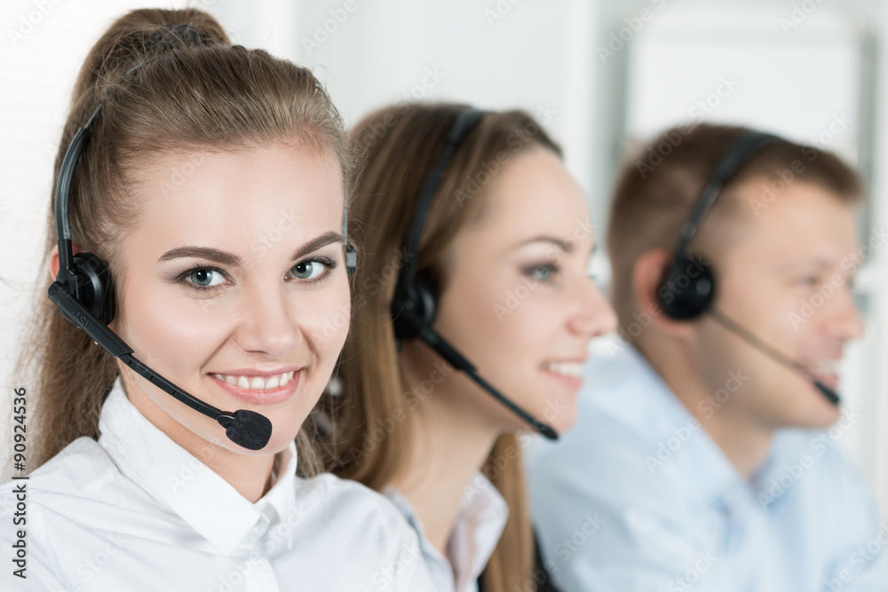 Portrait of call center worker accompanied by her team Portrait of call center worker accompanied by her team