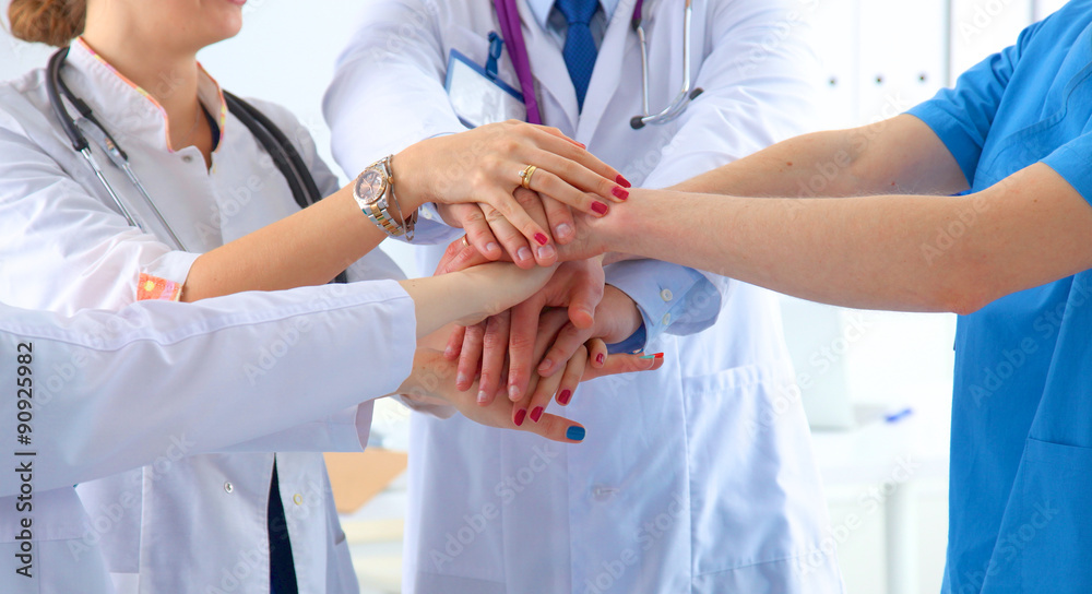 Doctors and nurses in a medical team stacking hands Doctors and nurses in a medical team stacking hands