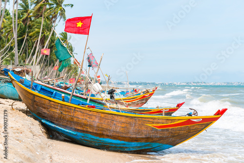 Vietnamese fishing coracles on beach, tribal boats at fishing village photo