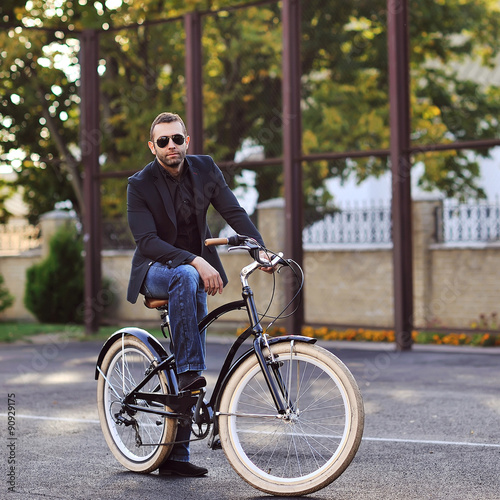 Young man on a vintage bicycle outdoor