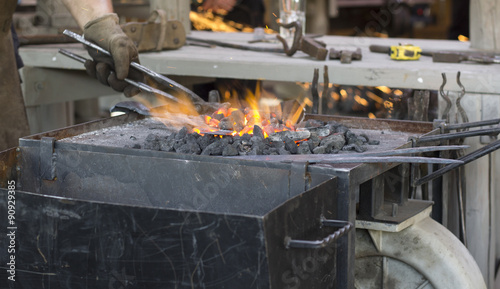 Fotografia, Obraz Piece of metal heated by a metal worker
