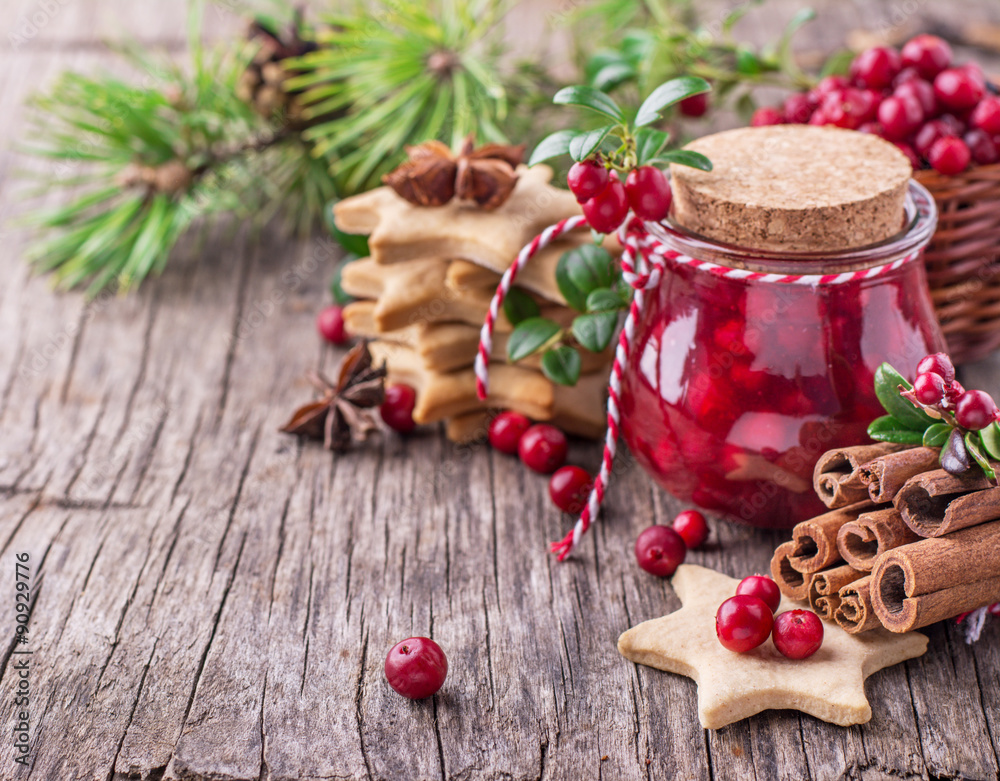 Cranberry sauce in a glass on wooden board Cranberry sauce in a glass on wooden board