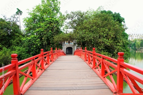 Huc Bridge over the Hoan Kiem Lake in Hanoi,Vietnam.The wooden red-painted bridge connects the shore and the Jade Island on which Ngoc Son Temple. photo