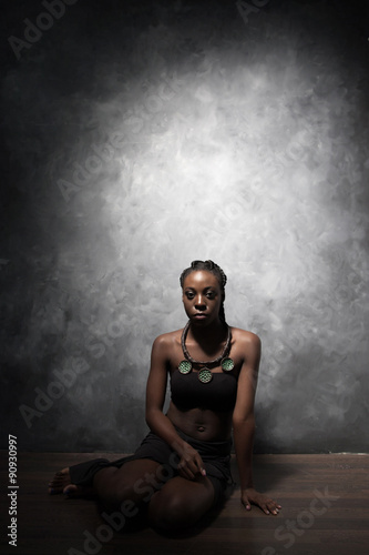 beautiful black woman sits on a floor
