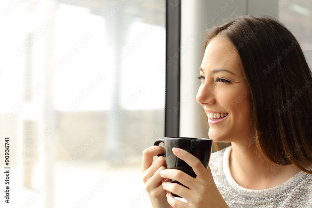 Passenger woman drinking coffee during a train travel
