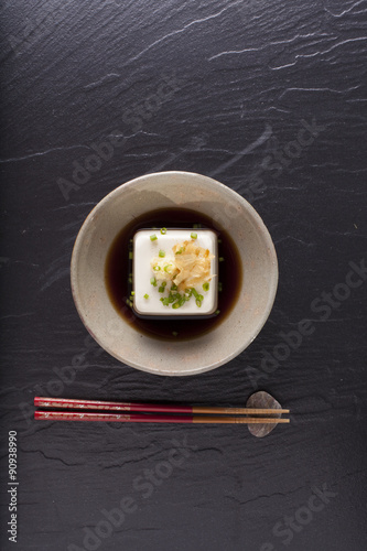 Japanese tofu, Japanese soft cold tofu with sauce in a dish on dining table