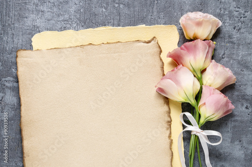 Bouquet of pink eustoma flowers on gray stone background