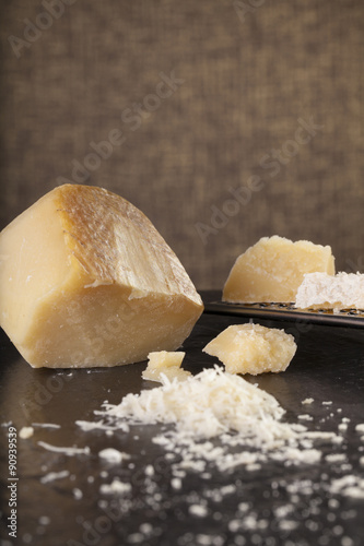 grated cheese, grated parmesan cheese with a grater and a jar and bottle of olive  oil