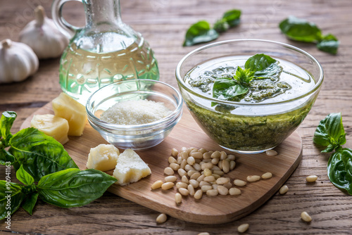 Pesto with ingredients on the wooden table