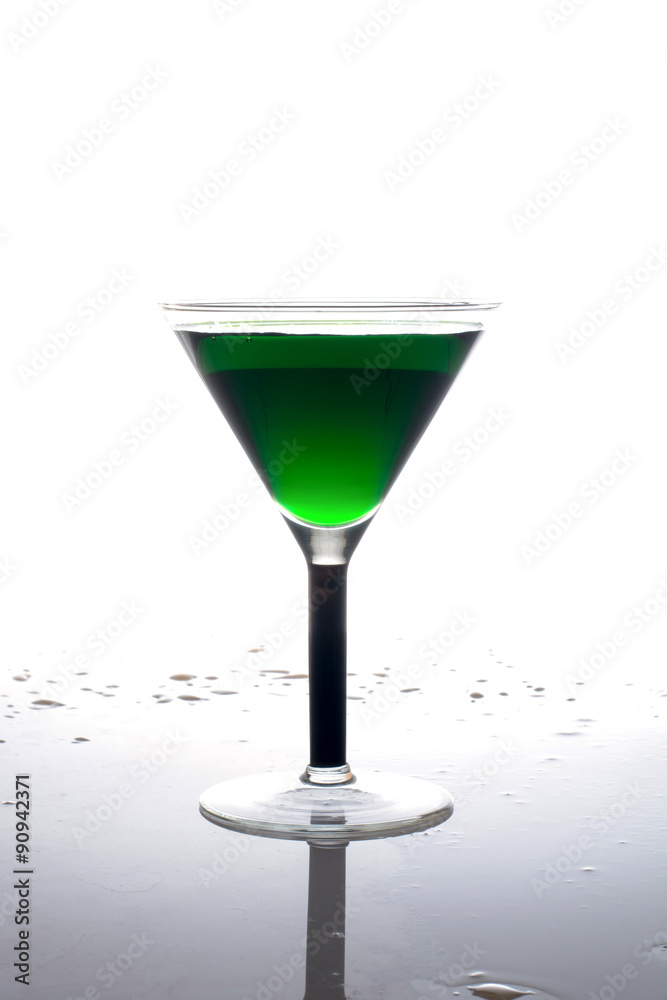 glass of green drink on a white background