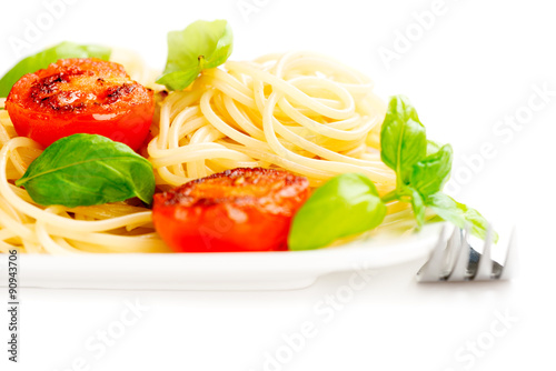 Traditional italian macaroni pasta with grilled tomato and orega photo