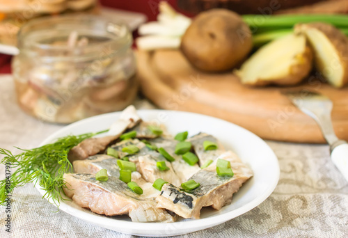 Pickled herring with green green onions and fennel.