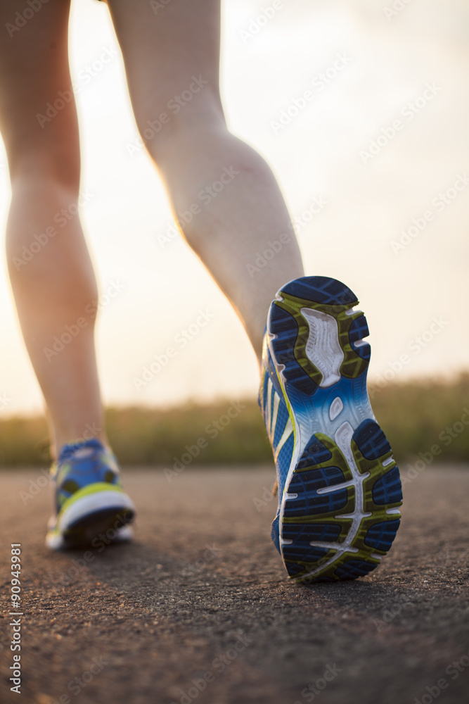 Runner feet running on road closeup on shoe