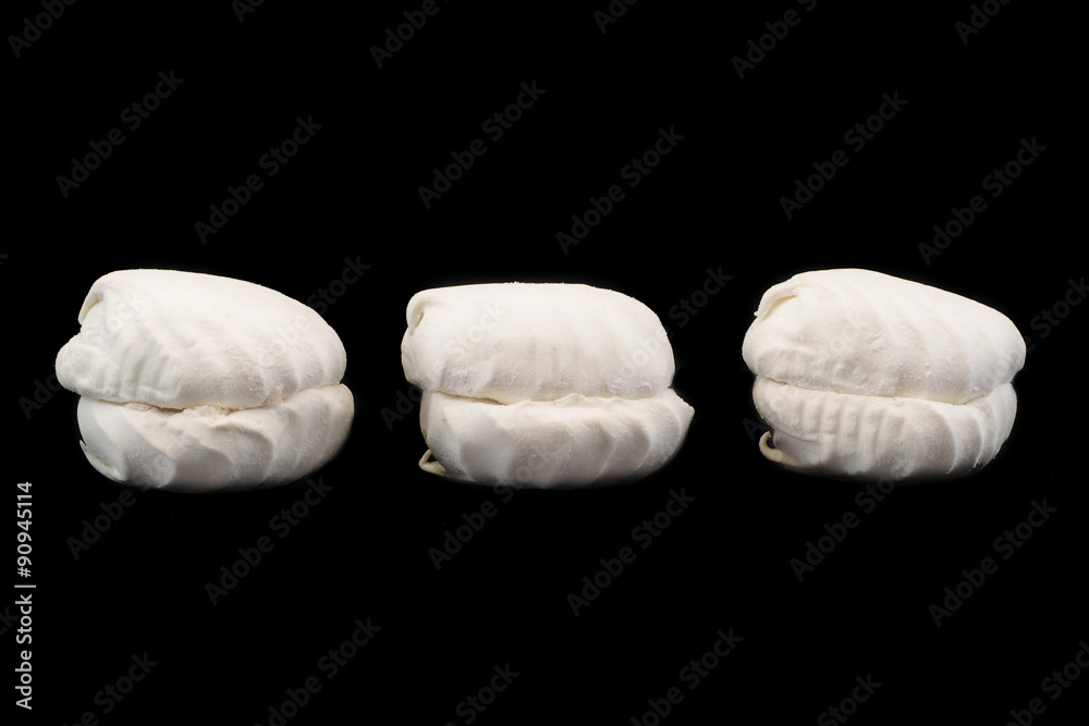 white marshmallows isolated on a black background white marshmallows isolated on a black background