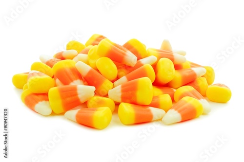 Pile of Halloween candy corn over a white background