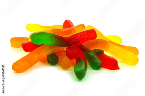 Pile of candy gummy worms over a white background photo