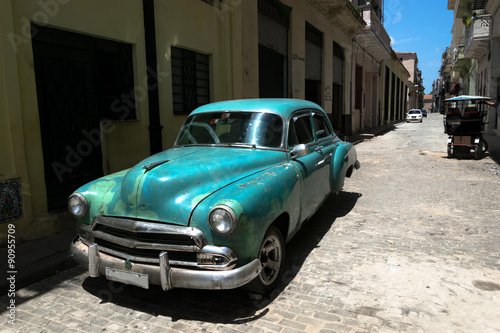 Green vintage car in Old Havana street