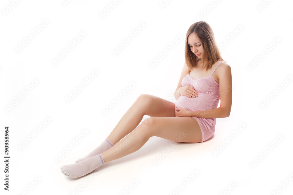 Cute pregnant woman in a good shape isolated on white background
