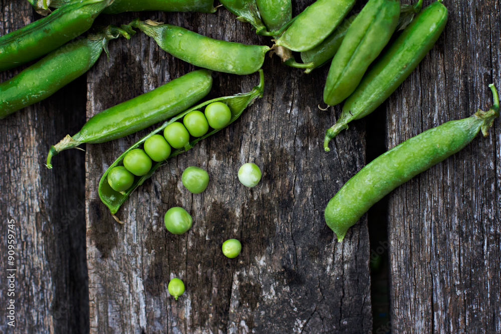Young fresh green peas on wooden background Young fresh green peas on wooden background
