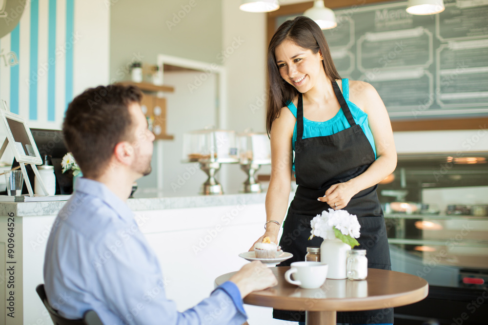 Pretty Latin waitress serving a cupcake Pretty Latin waitress serving a cupcake