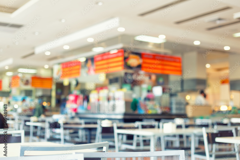 Food court or foodcourt interior blurred background. May called restaurant or canteen include coffee shop with table, people at indoor plaza, mall, store or shopping center in Chiang mai of Thailand.