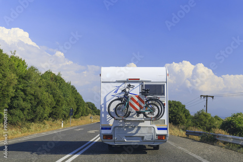 caravan back, bikes, road, speed , sky , trees