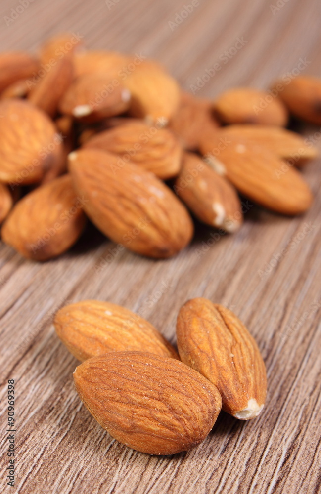 Heap of almonds on wooden background Heap of almonds on wooden background