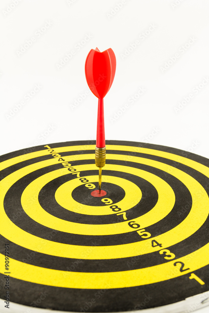 Red darts in bullseye of dartboard Red darts in bullseye of dartboard