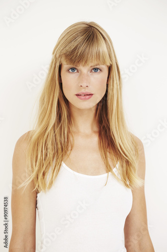 Portrait of beautiful young woman in white, studio