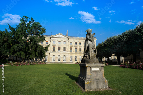 In a public garden park, genaral view of a statue and typical architecture Bordeaux, France