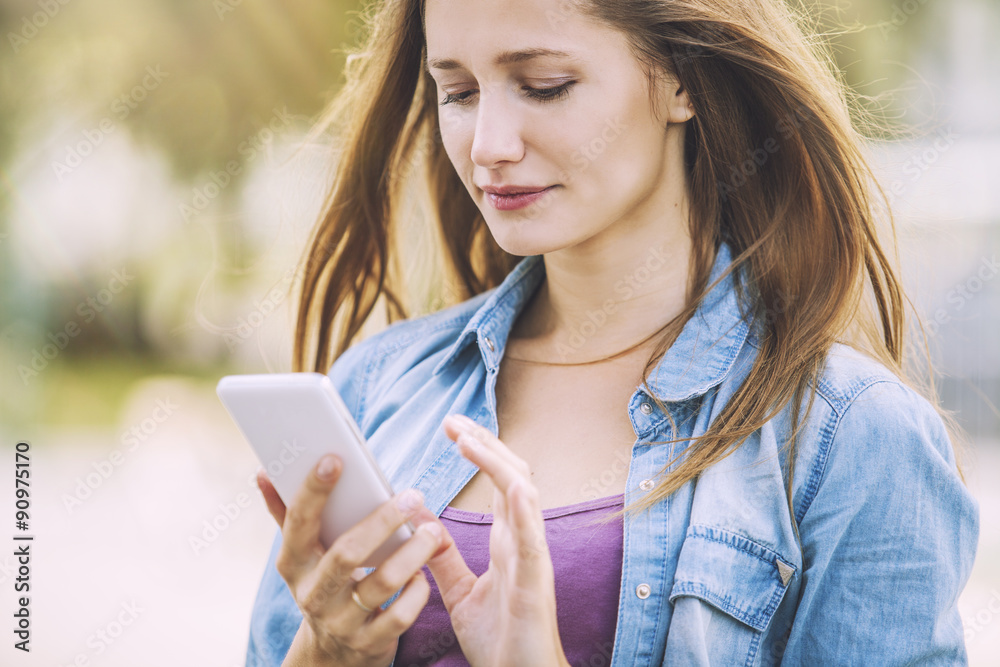 Woman beautiful model with a phone on the street Woman beautiful model with a phone on the street
