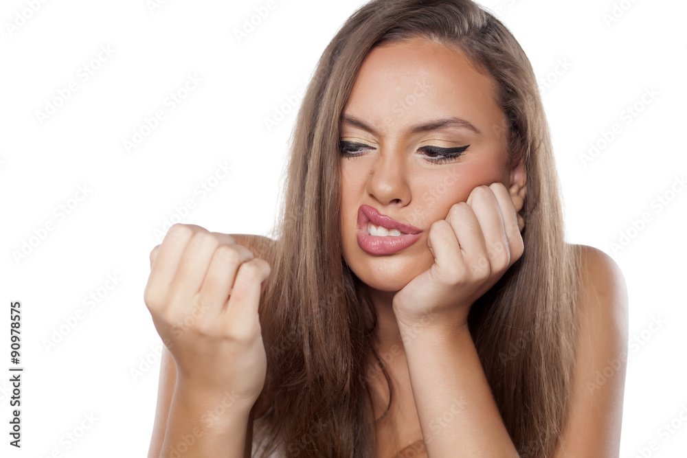 dissatisfied beautiful girl looking at her nails dissatisfied beautiful girl looking at her nails