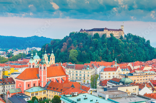 Aerial view of Ljubljana city with castle on hill, beautiful buildings and church in summertime, Slovenia