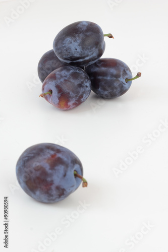 Closeup of ripe plums isolated on white.