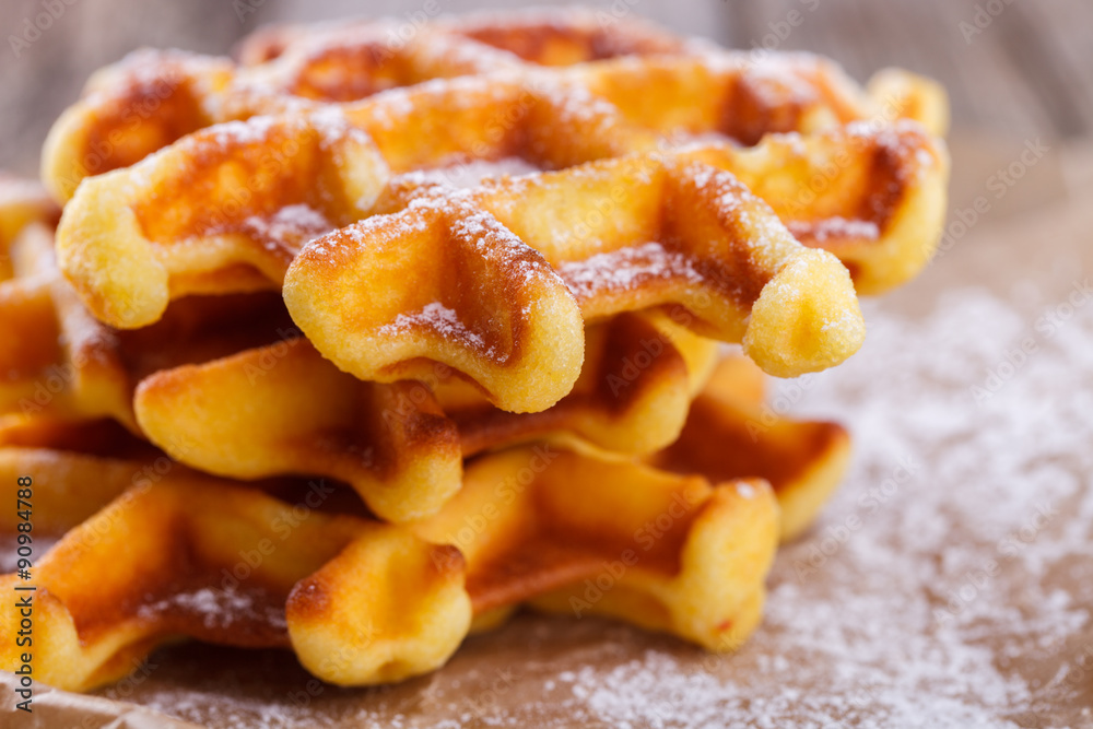 Belgian waffles sprinkled with powdered sugar,closeup.selective focus Belgian waffles sprinkled with powdered sugar,closeup.selective focus