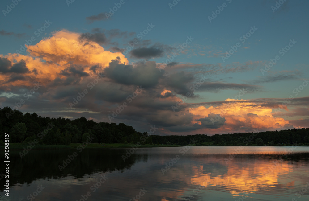 beautiful sky on a sunset over the forest lake