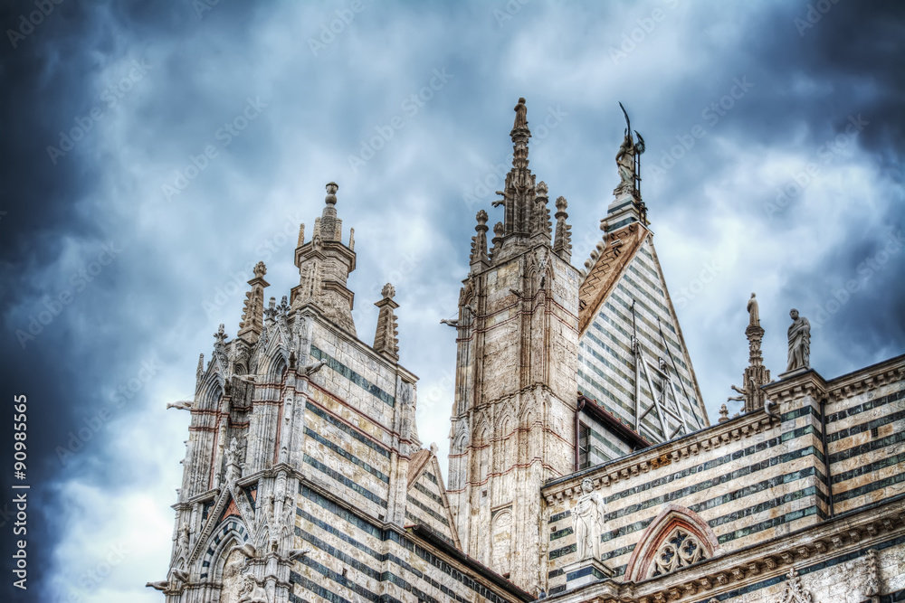 Santa Maria Assunta cathedral in Siena under a dramatic sky